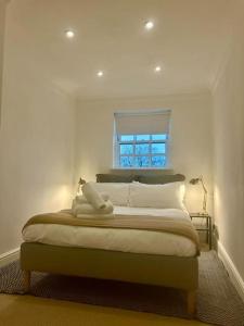a bedroom with a large bed with a window at Epic Location, Views & Large Private Terrace in Windsor