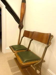 a wooden rocking chair sitting next to a wall at Epic Location, Views & Large Private Terrace in Windsor