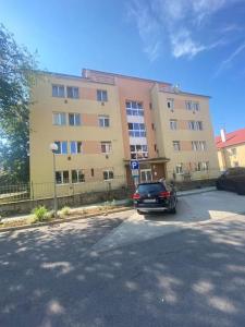 a car parked in a parking lot in front of a building at Apartmán v centre mesta Zvolen in Zvolen