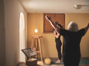 two women standing in a room with their arms in the air at B&B Mia Majon in Canazei