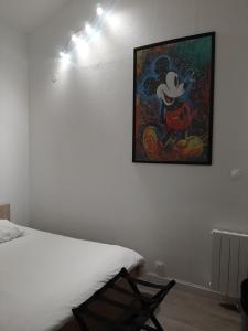 a bedroom with a painting of mickey mouse on the wall at Home-Sweet-Home Superbe appartement en hypercentre in La Rochelle