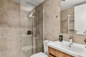 a bathroom with a shower and a toilet and a sink at Limehome Athens Solonos City Center in Athens