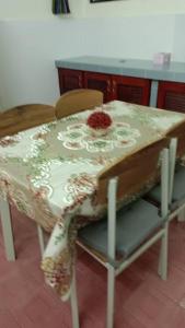 a table with a table cloth on top of it at Taiping Desa Jana Home Stay in Kamunting