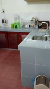 a kitchen with a sink and a counter at Taiping Desa Jana Home Stay in Kamunting