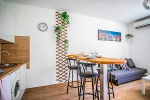 a dining room with a table and chairs in a kitchen at 21 Centre Historique - Gare- Place de la Comédie in Montpellier