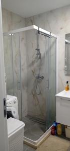 a shower with a glass door in a bathroom at Happy Place apartment 1 bedroom in Bar