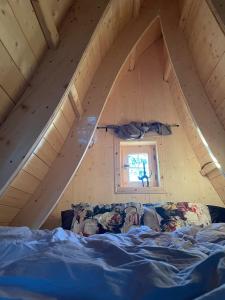 a bedroom with a bed in a attic at Fairytale tinyhouse near the sea - Häxans hus in Gothem