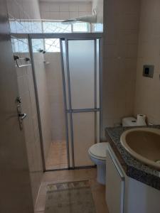 a bathroom with a shower and a toilet and a sink at Mar e Descanso in Maceió