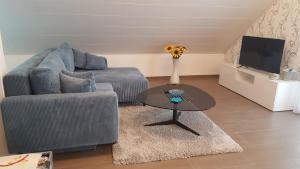 a living room with a couch and a table at Ferienhaus Fee in Erbach