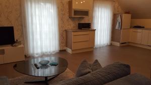 a living room with a couch and a glass table at Ferienhaus Fee in Erbach +16 photos