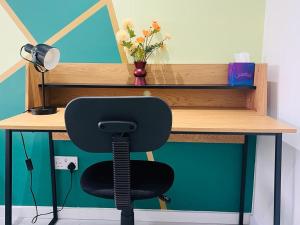 a desk with a chair sitting in front of a desk at Stylish studio in Milton Keynes