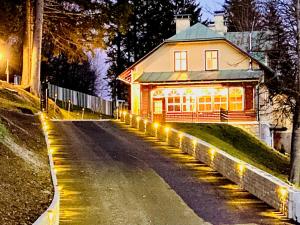 a house with lights on the side of a road at Mariazeller Alpen Chalet in Mariazell