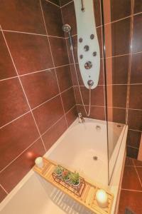 a bathroom with a bath tub with a shower at Simple 2 Bed in Central Dewsbury - Sleep 4 in Dewsbury