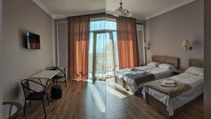 Letto o letti in una camera di FRESH Hotel Kobuleti
