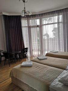 a hotel room with two beds and a window at FRESH Hotel Kobuleti in K'obulet'i