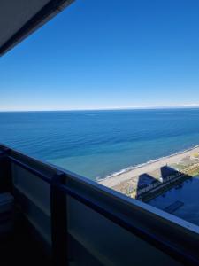 a view of the ocean from the balcony of a building at ORBI CITY - Sea Side Apartments in Batumi