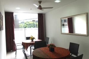 a dining room with two tables and a large window at Hotel Min Cott in Kuala Lumpur