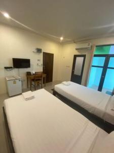 Postel nebo postele na pokoji v ubytování Jitra Resort