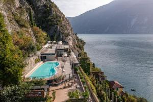 a resort on the side of a mountain next to the water at Hotel Villa Dirce - Adults Only Hotel in Limone sul Garda