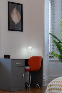 an office with a desk and a red chair at Open Mind Property - Heart of Portsmouth City Centre - Step Away from University in Portsmouth