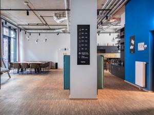 a large room with a table and chairs at Numa Frankfurt Bloc in Frankfurt