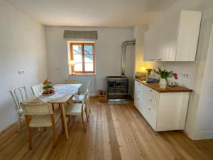 a kitchen and dining room with a table and chairs at Luisenhof in Hannersdorf