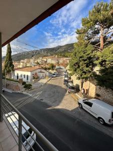a view of a street with a white car parked on the road at THOLOS HOTEL in Delphi