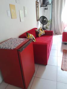 a red couch sitting in a living room at CactusStudio in Salvador