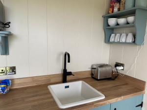 a kitchen counter with a sink and a toaster at Burren Garden Glamping Hut in Boston