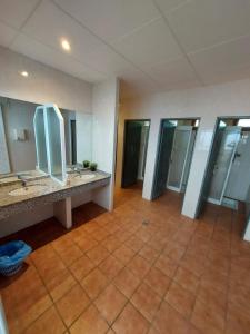a large bathroom with two sinks and mirrors at Camping Solau in Espot