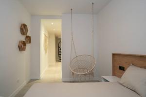 a bedroom with a hammock hanging from a wall at Sahara Apt Central Benalmadena in Benalmádena