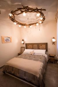 a bedroom with a large bed with lights on the ceiling at La Serra Sognante Guest house con giardino in Florence