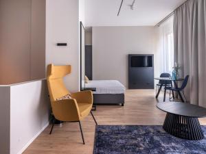 a room with a bed and a chair and a table at Numa Frankfurt Bloc in Frankfurt +58 photos