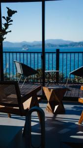 a balcony with chairs and a view of the water at sauna×star×sea　Highland Panorama Ocean View in Shima