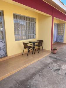 a patio with two chairs and a table on a house at Hillmaac Nest in Eldoret