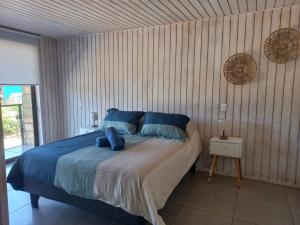 A bed or beds in a room at Puerta Punta de Lobos