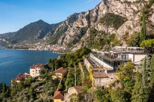 a town on a mountain next to the water at Hotel Villa Dirce in Limone sul Garda