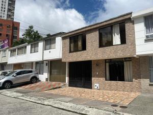 a car parked in front of a brick building at Bhospedaje in Manizales