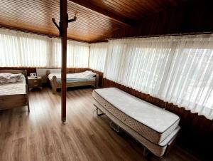 a bedroom with two beds and a wooden ceiling at Halic Apart Hotel in Yalova