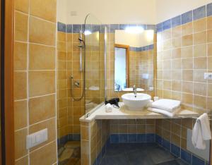 a bathroom with a sink and a shower at Sa Tirìa in Chia