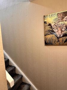 a painting of a leopard hanging on a wall at Apartment in Greenwich in London