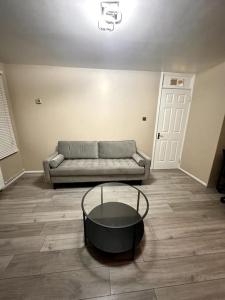 a living room with a couch and a table at Apartment in Greenwich in London