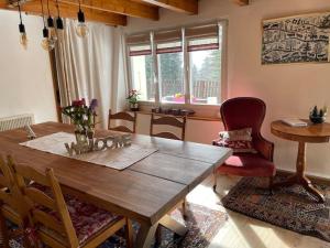 a dining room with a wooden table and chairs at La grande garde in Les Avants