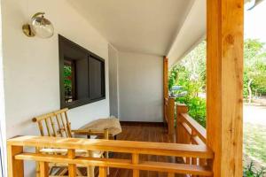 a room with a table and chairs and a television at BangPo Resort in Ban Bang Po