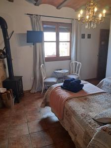 a bedroom with a bed and a table and chairs at Ca la Serreta in Cretas