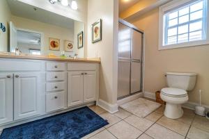 a bathroom with a shower and a toilet and a sink at Central Ave Getaway with Elevator in Ocean City +5 photos