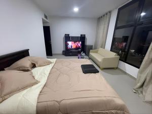 a bedroom with a large bed and a television at Adorable Master Room - Heart of Abu Dhabi in Abu Dhabi +73 photos