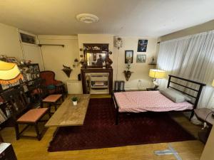 a living room with two beds and a table at Highgate Hill Room! in London