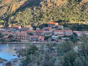 a town next to a river and a mountain at Residence Appartement in Porto Ota