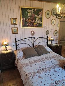a bedroom with a bed and a painting on the wall at Ca la Serreta in Cretas